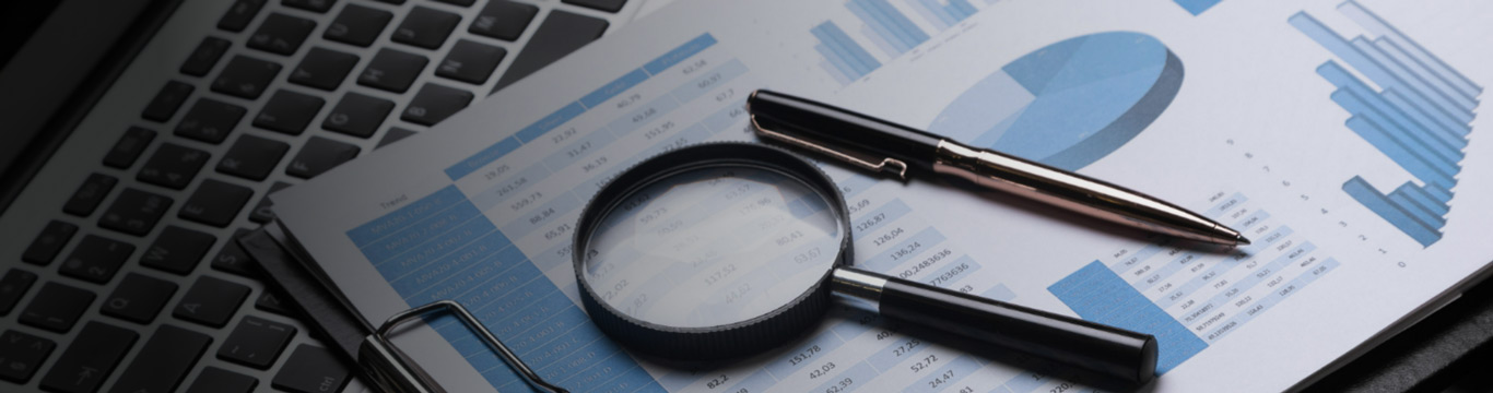 Financial charts, laptop and analysis tools
