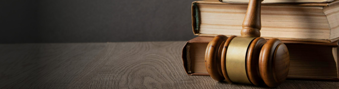Law books and a wooden gavel